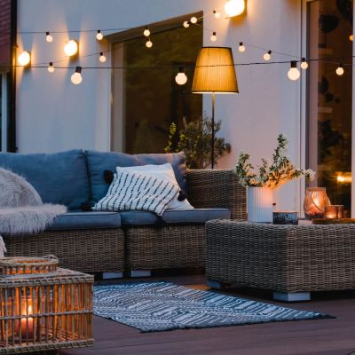 Patio with stylish decor and lighting in the evening