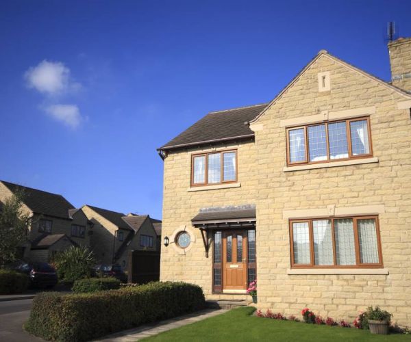 stone-walled house with timber-effect uPVC windows