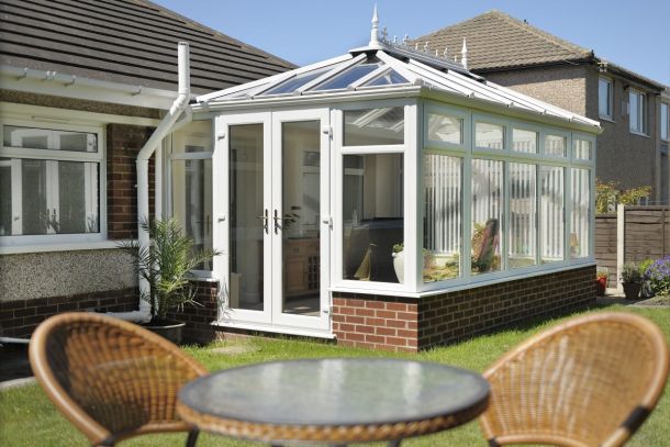 external view of a conservatory with french door and polycarbonate roof.