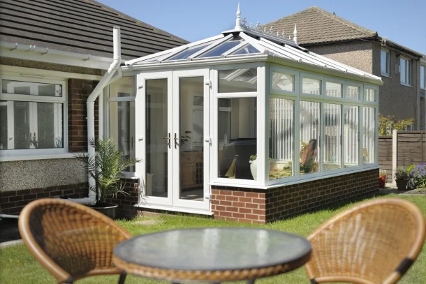 external view of a conservatory with french door and polycarbonate roof.