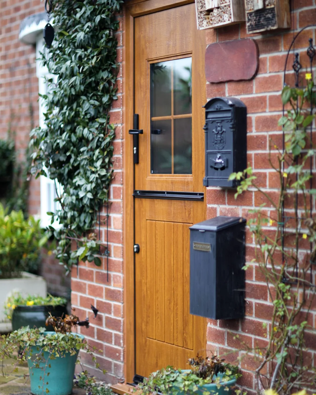 rockdoor stable composite door in golden oak with black furniture