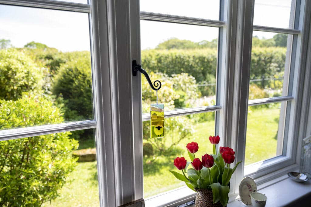 Traditional white window overlooking beautiful garden