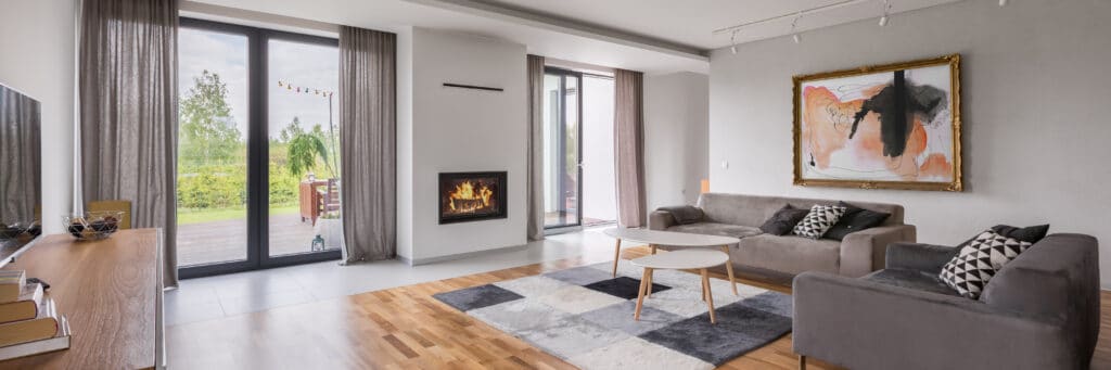 modern living room with two sofas and two sets of bifolding doors.