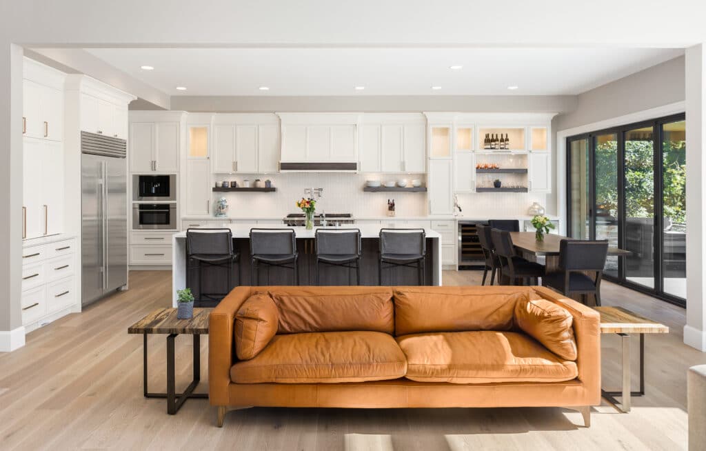 A modern open plan kitchen / living room with a set of black bifolding doors.