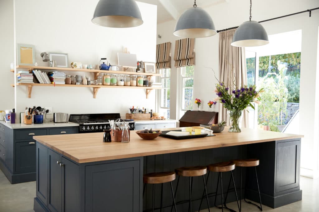 A modern kitchen with french doors and sliding sash windows.