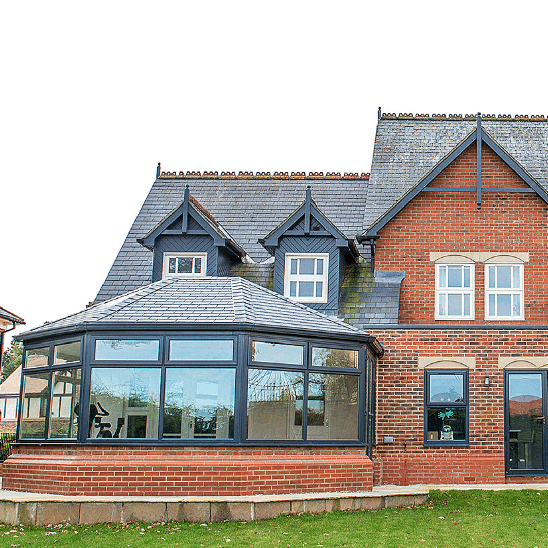 Facade of large house with Guardian Warm Roof conservatory