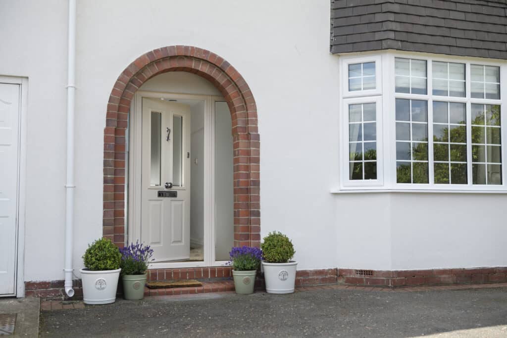 Traditional front door beneath brick arch