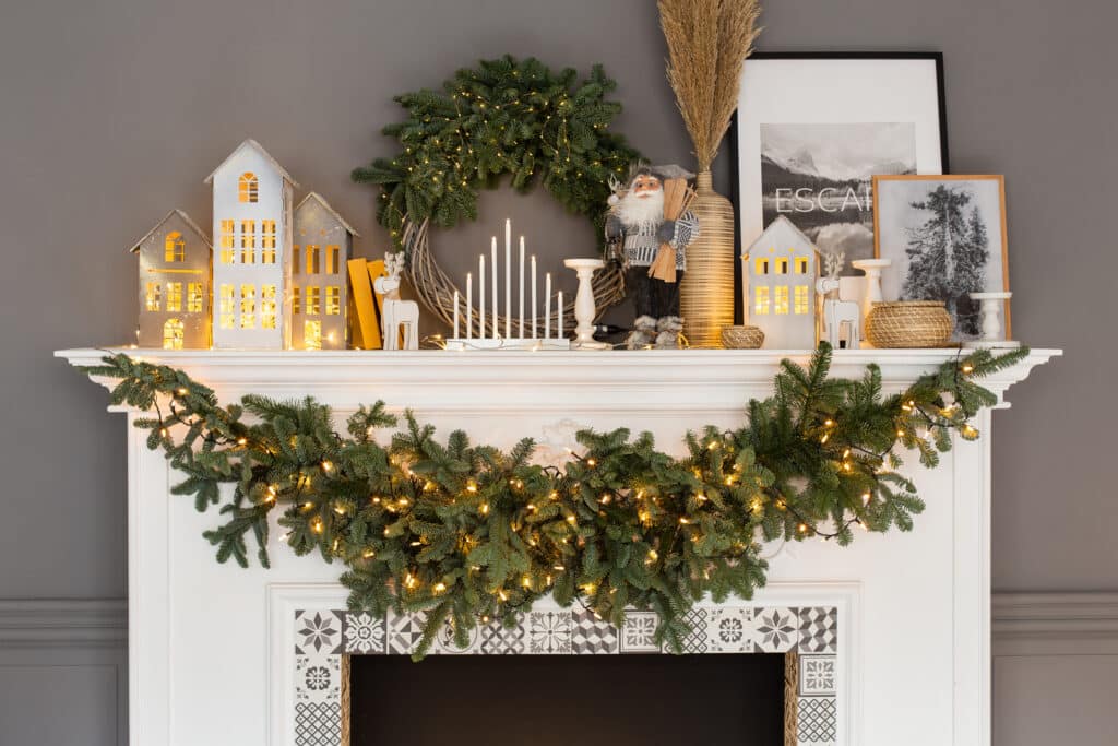 christmas decorations on top of a fireplace
